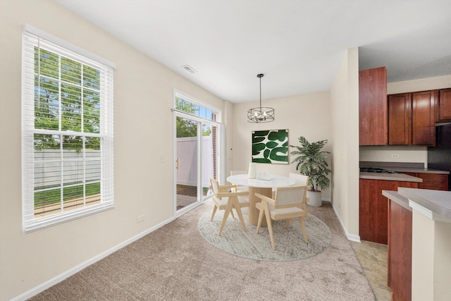 1133 Heron Cir, Joliet, IL 60431 - dining room with baseboards, a chandelier, and light colored carpet
