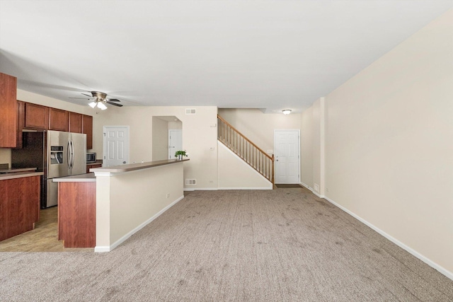 1133 Heron Cir, Joliet, IL 60431 - kitchen featuring stainless steel refrigerator with ice dispenser, light colored carpet, brown cabinetry, and ceiling fan