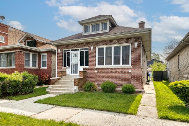 7637 S Ridgeland Ave, Chicago, IL 60649 - view of front of property with brick siding, a chimney, and a shingled roof