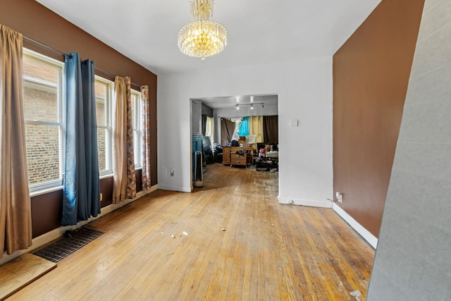 7637 S Ridgeland Ave, Chicago, IL 60649 - foyer with a chandelier, wood-type flooring, and baseboards