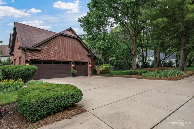 1033 Forest Trl, Sugar Grove, IL 60554 - view of home's exterior featuring concrete driveway, brick siding, and a garage