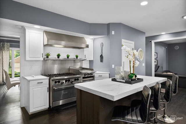 1033 Forest Trl, Sugar Grove, IL 60554 - kitchen featuring wall chimney range hood, high end stainless steel range oven, dark wood finished floors, a center island, and decorative backsplash