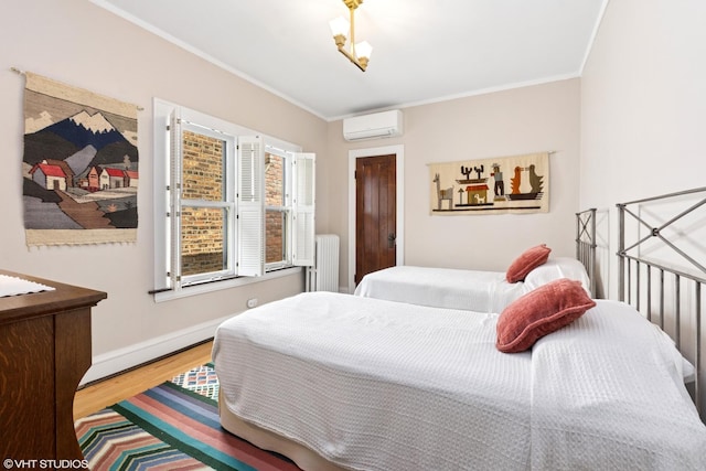 2558 W Cullom Ave, Chicago, IL 60618 - bedroom with radiator heating unit, wood finished floors, ornamental molding, and an AC wall unit