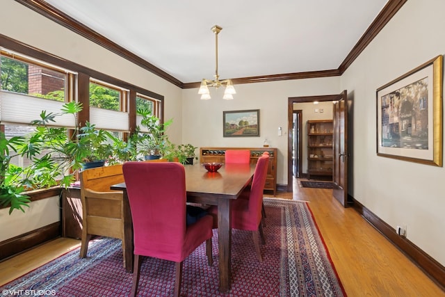 2558 W Cullom Ave, Chicago, IL 60618 - dining room featuring a chandelier, wood finished floors, and crown molding