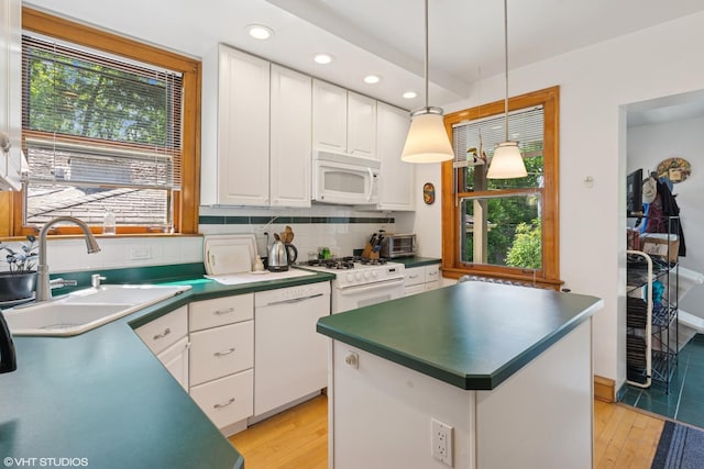 2558 W Cullom Ave, Chicago, IL 60618 - kitchen with white appliances, recessed lighting, white cabinets, light wood finished floors, and decorative backsplash