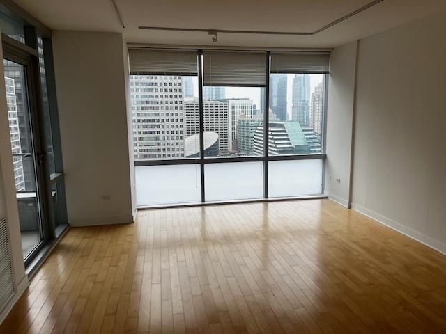8 E Randolph St Unit 3206, Chicago, IL 60601 - spare room featuring wood-type flooring, floor to ceiling windows, and baseboards