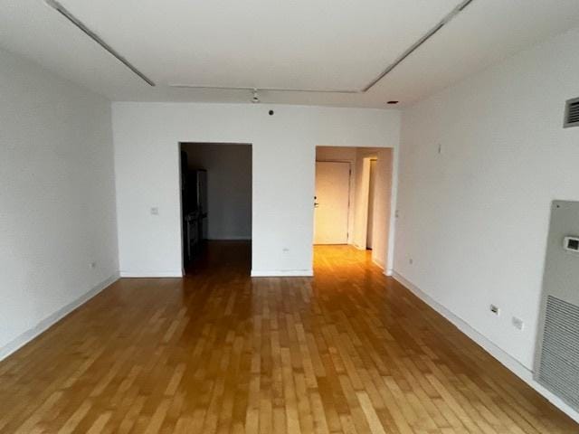 8 E Randolph St Unit 3206, Chicago, IL 60601 - empty room featuring wood finished floors, a heating unit, and baseboards