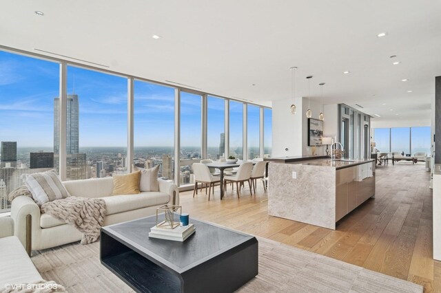 363 E Wacker Dr Unit 6301, Chicago, IL 60601 - living area with a wall of windows, light wood-style floors, and recessed lighting