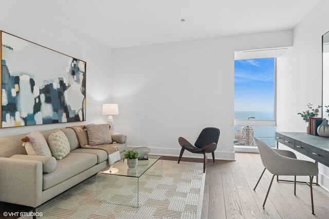 363 E Wacker Dr Unit 6301, Chicago, IL 60601 - living room with hardwood / wood-style floors, a water view, and baseboards