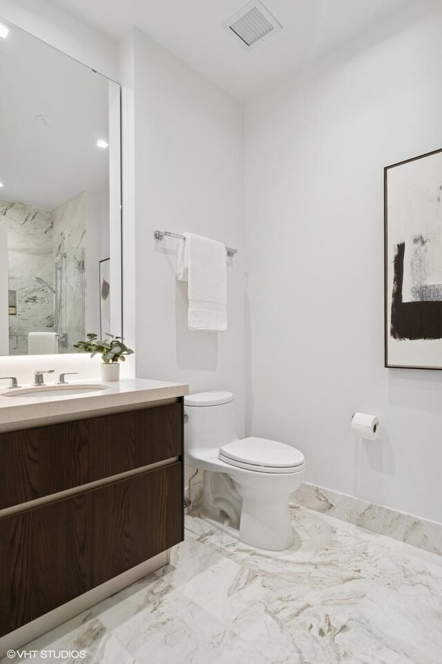 363 E Wacker Dr Unit 6301, Chicago, IL 60601 - full bathroom featuring toilet, a marble finish shower, vanity, and marble look tile flooring