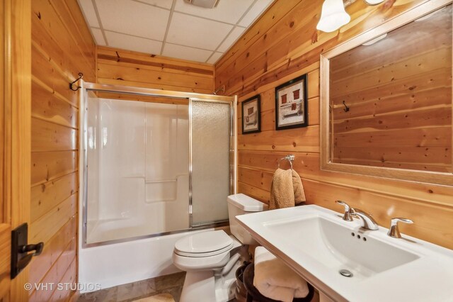 2317 Paulson Rd, Harvard, IL 60033 - bathroom featuring wood walls, toilet, bath / shower combo with glass door, and vanity
