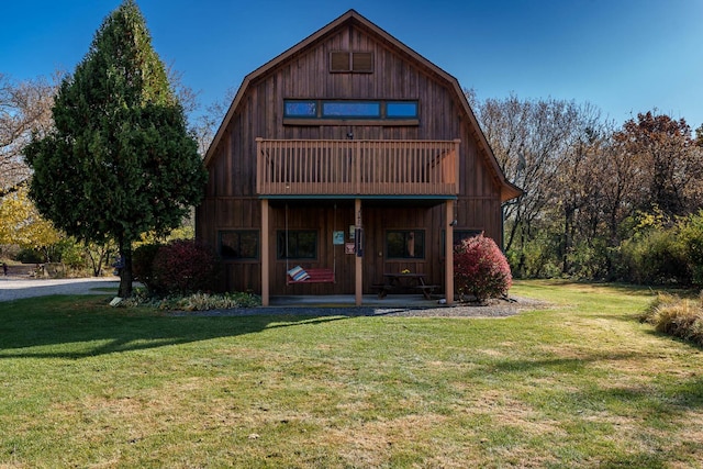2317 Paulson Rd, Harvard, IL 60033 - rear view of house with a gambrel roof, a lawn, and a porch