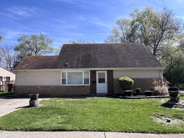 409 Winnemac St, Park Forest, IL 60466 - view of front of property with brick siding, a front lawn, and roof with shingles