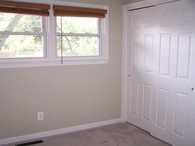 1711 Beach Rd, Mchenry, IL 60050 - unfurnished bedroom featuring light carpet and a closet