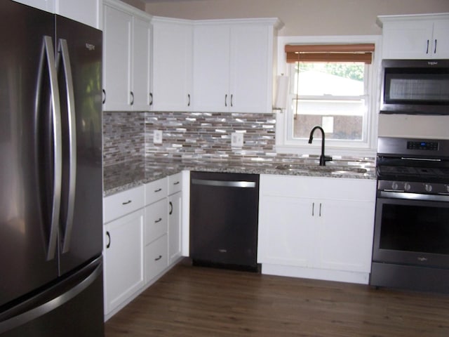 1711 Beach Rd, Mchenry, IL 60050 - kitchen with appliances with stainless steel finishes, light stone counters, tasteful backsplash, and white cabinetry