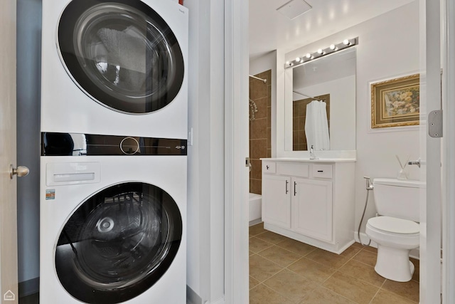 1629 S Prairie Ave Unit 1803, Chicago, IL 60616 - laundry area with stacked washer / drying machine, light tile patterned flooring, and baseboards