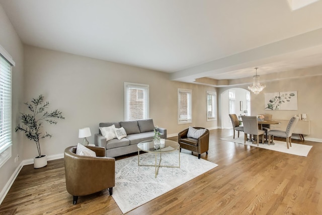 19 S Home Ave, Park Ridge, IL 60068 - living area featuring plenty of natural light, wood finished floors, arched walkways, and baseboards