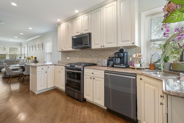 889 S Golf Cul De Sac St, Des Plaines, IL 60016 - kitchen featuring appliances with stainless steel finishes, plenty of natural light, a peninsula, ornamental molding, and wood finished floors