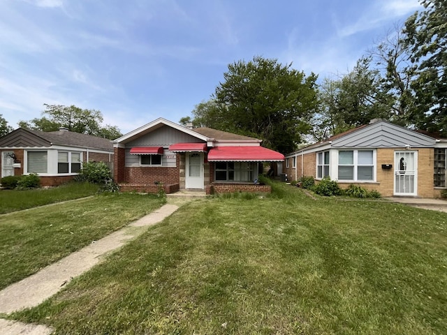 14404 University Ave, Dolton, IL 60419 - view of front of home featuring brick siding and a front yard