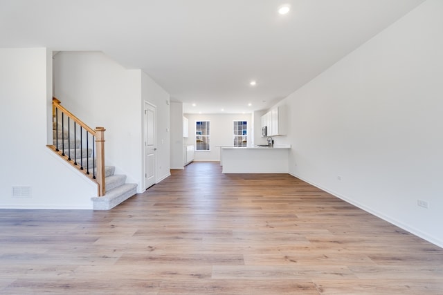 1905 Neubauer Cir Unit 1003, Lindenhurst, IL 60046 - unfurnished living room with stairs, light wood-style flooring, and recessed lighting