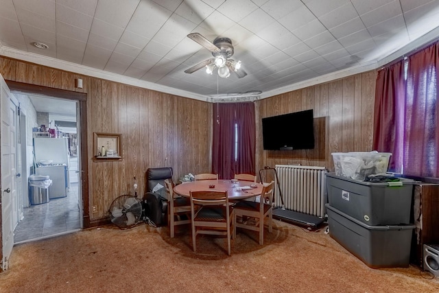 1032 S Maple Ave, Oak Park, IL 60304 - carpeted dining space with ceiling fan, wood walls, radiator, and ornamental molding