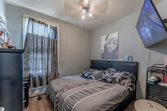 1032 S Maple Ave, Oak Park, IL 60304 - bedroom with wood finished floors, baseboard heating, and a ceiling fan