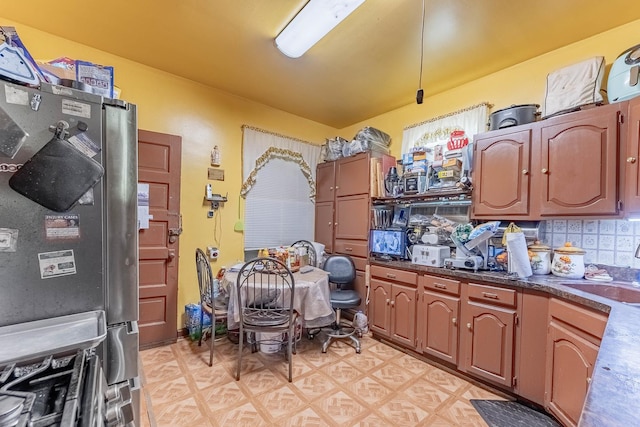 1032 S Maple Ave, Oak Park, IL 60304 - kitchen with freestanding refrigerator, dark countertops, decorative backsplash, and light floors
