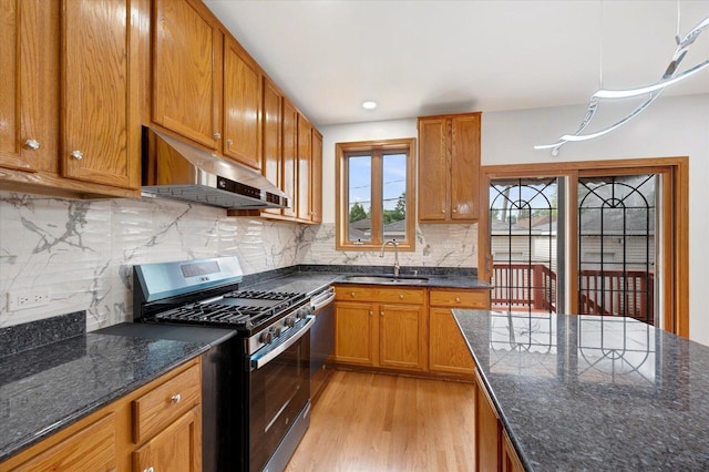 1019 W 47th Pl, Chicago, IL 60609 - kitchen featuring under cabinet range hood, appliances with stainless steel finishes, light wood finished floors, and brown cabinets