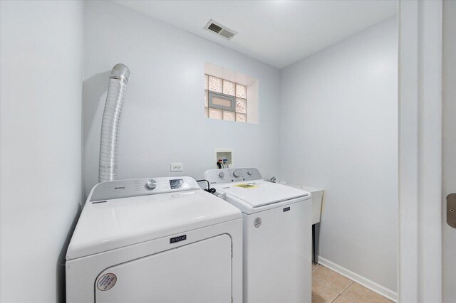 1019 W 47th Pl, Chicago, IL 60609 - laundry area featuring washer and clothes dryer and light tile patterned floors