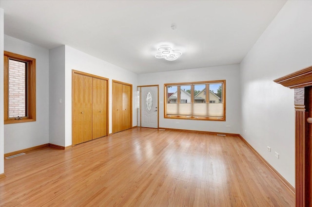 1019 W 47th Pl, Chicago, IL 60609 - unfurnished bedroom featuring two closets and light wood-style floors