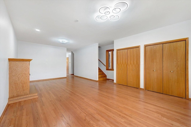 1019 W 47th Pl, Chicago, IL 60609 - unfurnished living room with light wood-type flooring and stairs
