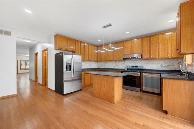 1019 W 47th Pl, Chicago, IL 60609 - kitchen with stainless steel appliances, under cabinet range hood, light wood-type flooring, tasteful backsplash, and recessed lighting