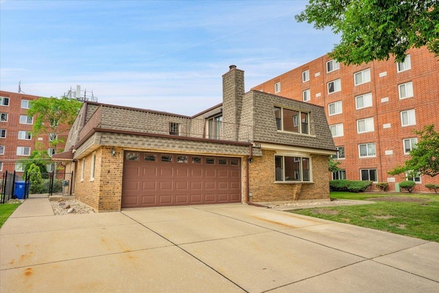 901 E Ardyce Ln, Mount Prospect, IL 60056 - view of front of home with mansard roof, roof with shingles, brick siding, an attached garage, and a chimney