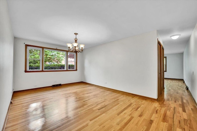 901 E Ardyce Ln, Mount Prospect, IL 60056 - unfurnished room featuring a chandelier and light wood-type flooring