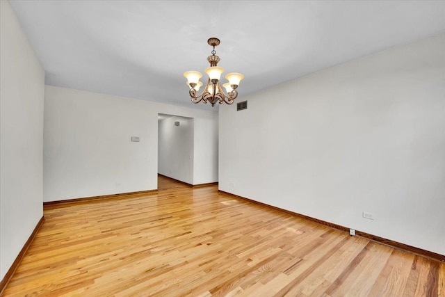 901 E Ardyce Ln, Mount Prospect, IL 60056 - spare room with light wood finished floors and a chandelier