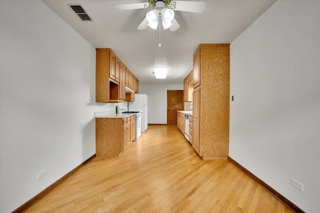 901 E Ardyce Ln, Mount Prospect, IL 60056 - kitchen featuring white appliances, light countertops, ceiling fan, and light wood-style flooring