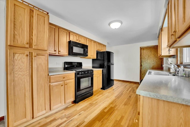901 E Ardyce Ln, Mount Prospect, IL 60056 - kitchen featuring black appliances, light wood-type flooring, light countertops, and light brown cabinets