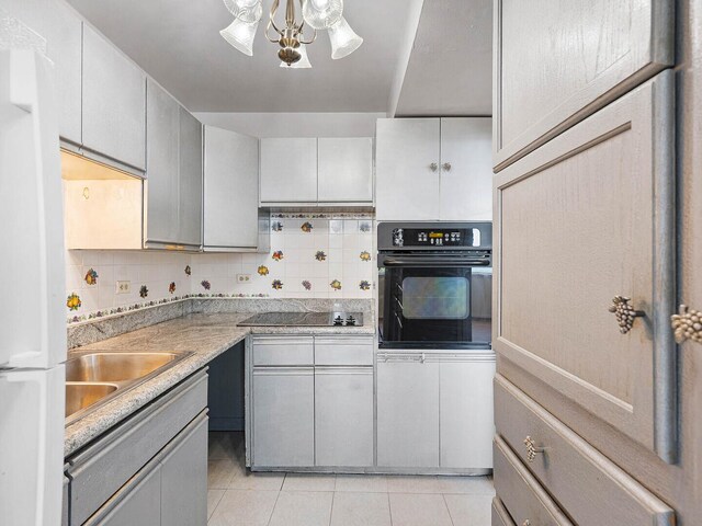 6301 N Sheridan Rd Unit 7G, Chicago, IL 60660 - kitchen with black appliances, decorative backsplash, light tile patterned floors, and a sink