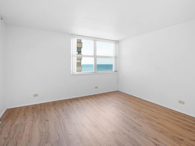 6301 N Sheridan Rd Unit 7G, Chicago, IL 60660 - spare room with wood finished floors, baseboards, and a water view
