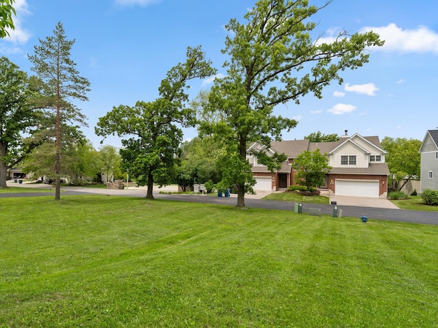 2508 Reflections Dr, Crest Hill, IL 60403 - view of front of property featuring a front lawn, asphalt driveway, brick siding, and a garage