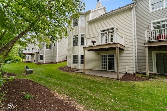 2508 Reflections Dr, Crest Hill, IL 60403 - back of property with a chimney, a yard, a patio, and a balcony