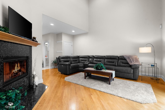 2508 Reflections Dr, Crest Hill, IL 60403 - living area with wood finished floors, baseboards, a fireplace, a high ceiling, and recessed lighting