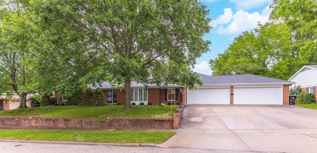 212 Mays Dr, Bloomington, IL 61701 - ranch-style home with concrete driveway, a garage, a front yard, and brick siding