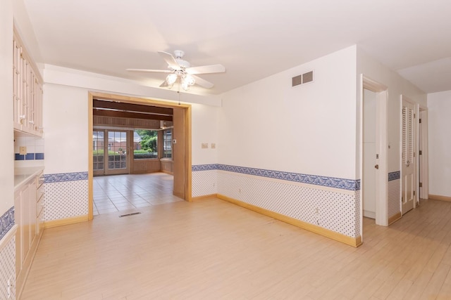 212 Mays Dr, Bloomington, IL 61701 - unfurnished room with ceiling fan, light wood-type flooring, wainscoting, and baseboards