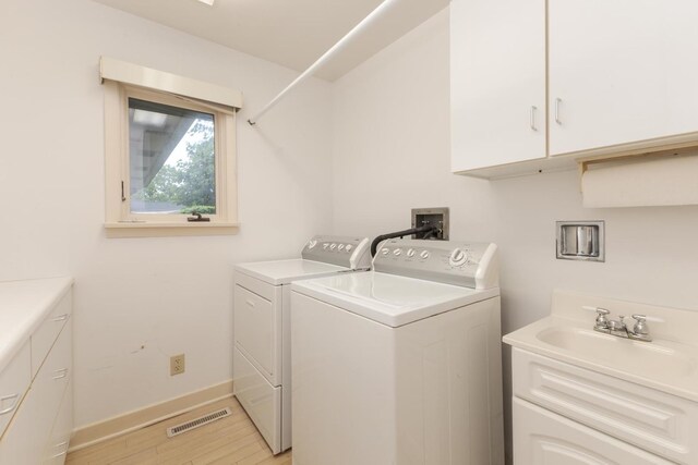 212 Mays Dr, Bloomington, IL 61701 - washroom featuring separate washer and dryer, light wood-style floors, cabinet space, and baseboards