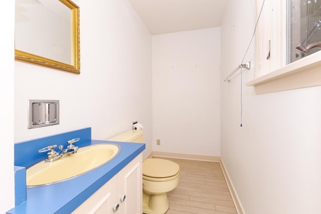 212 Mays Dr, Bloomington, IL 61701 - bathroom with vanity, toilet, wood finished floors, and baseboards