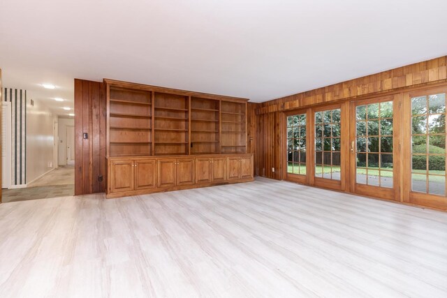 212 Mays Dr, Bloomington, IL 61701 - unfurnished living room featuring wooden walls and light wood finished floors