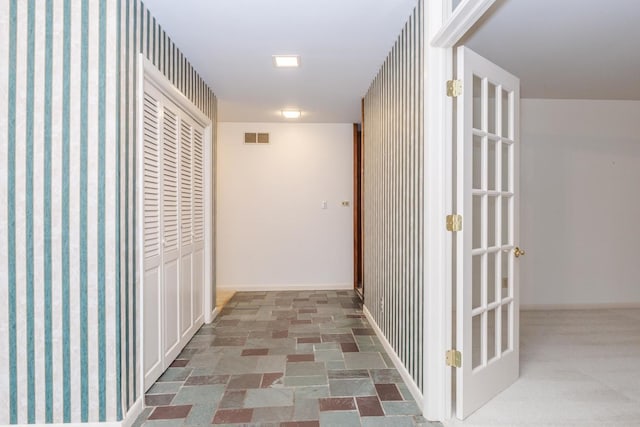 212 Mays Dr, Bloomington, IL 61701 - corridor featuring baseboards, stone finish floors, and wallpapered walls