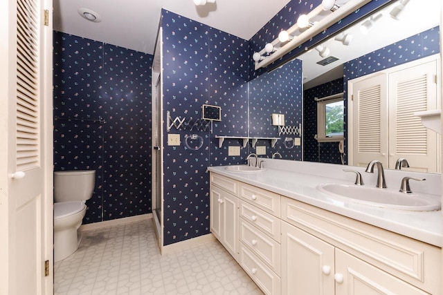 212 Mays Dr, Bloomington, IL 61701 - full bathroom with wallpapered walls, toilet, double vanity, and baseboards