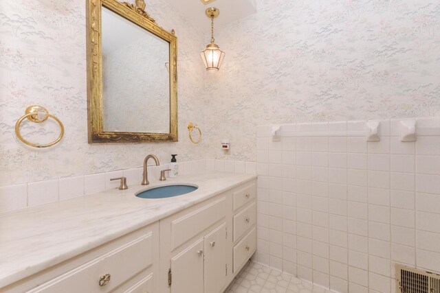 212 Mays Dr, Bloomington, IL 61701 - bathroom featuring wallpapered walls, vanity, tile patterned floors, and tile walls